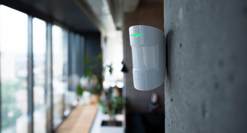 Ajax CombiProtect combined motion and glass break detector in white, angled view